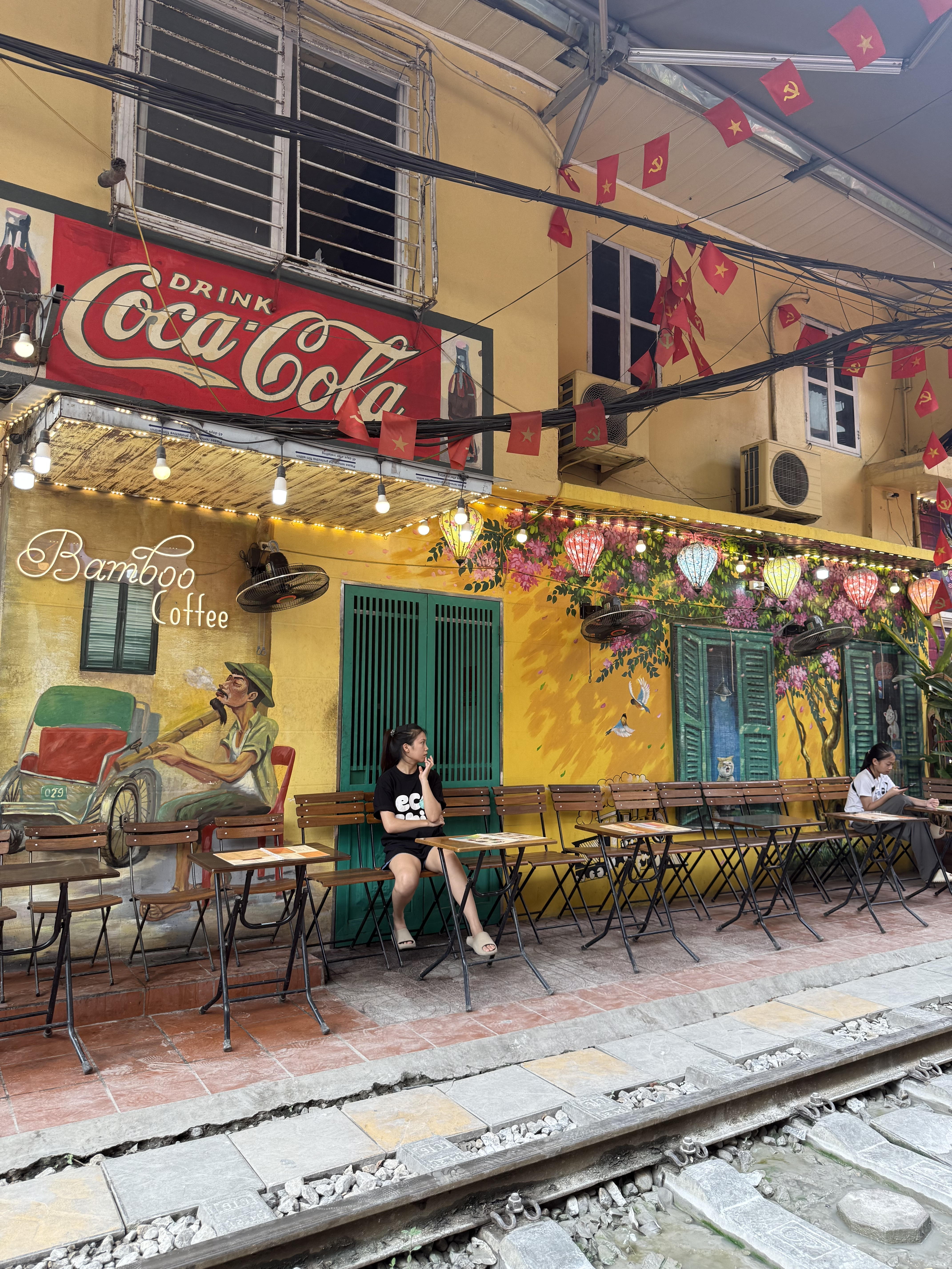 Cafés and lantern-lit awnings along Hanoi's Train Street, Fitrip Vietnam