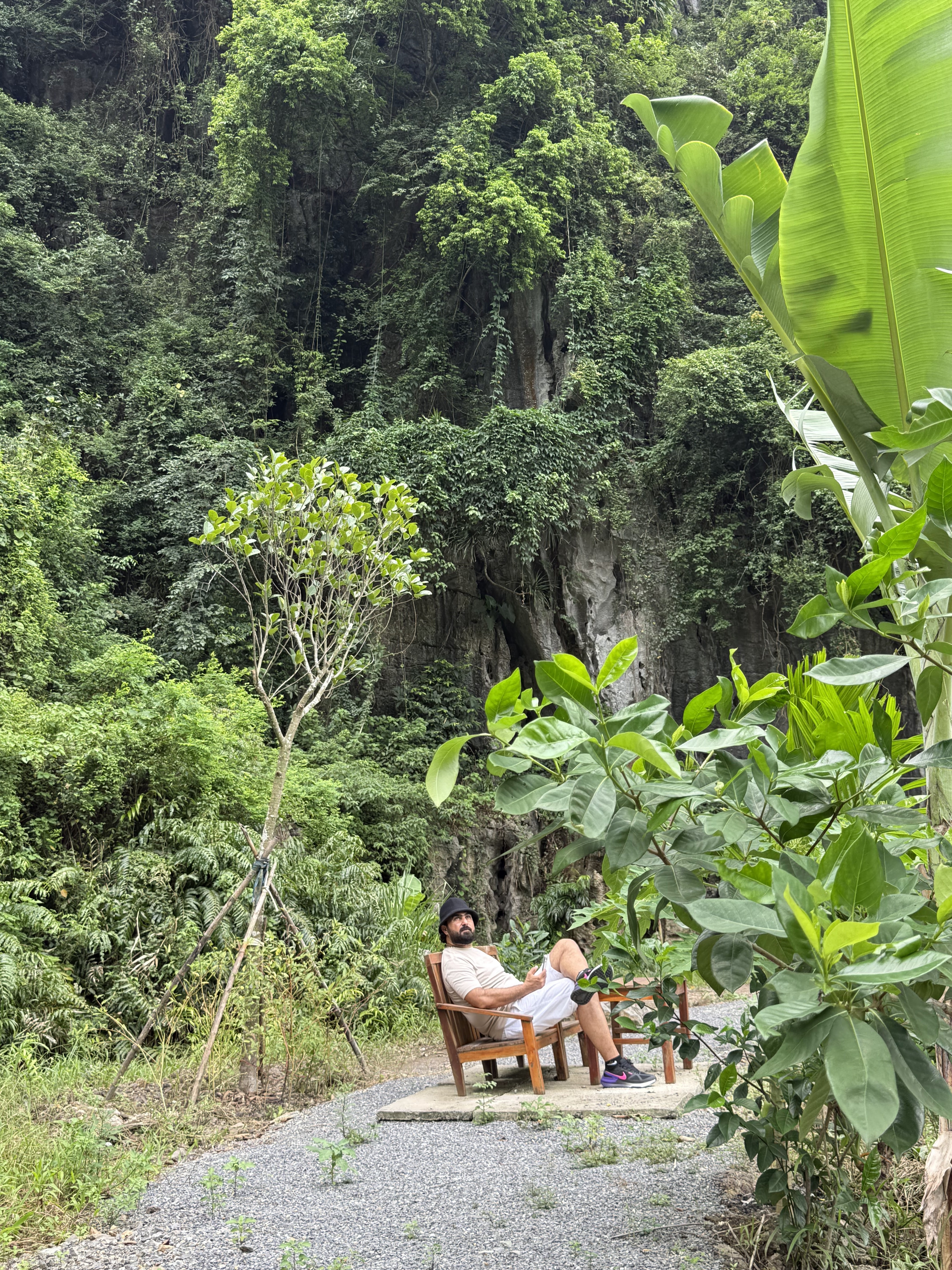 Resting beneath a limestone cliff in Trang An, Northern Vietnam