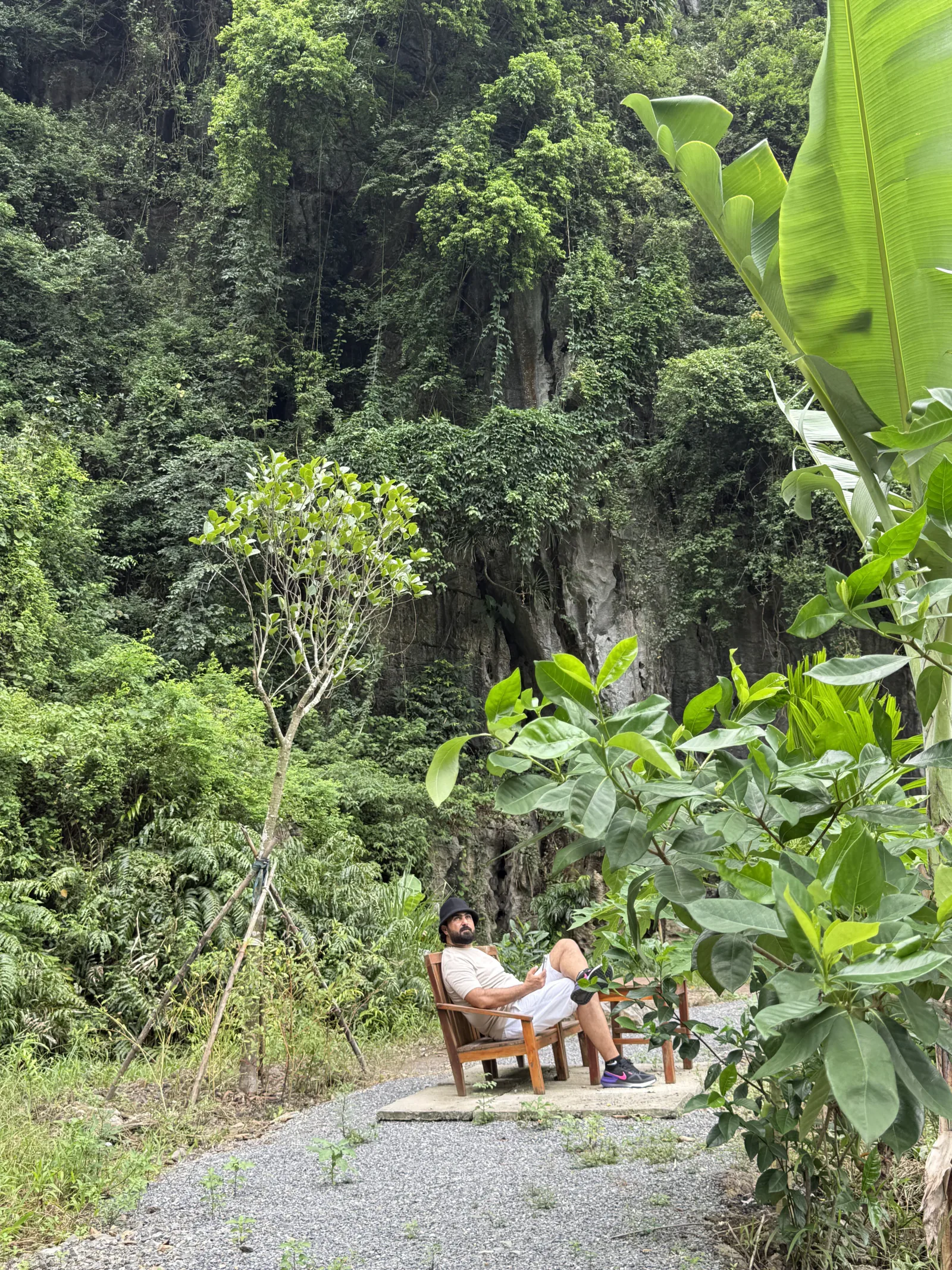 Resting beneath a limestone cliff in Trang An, Northern Vietnam