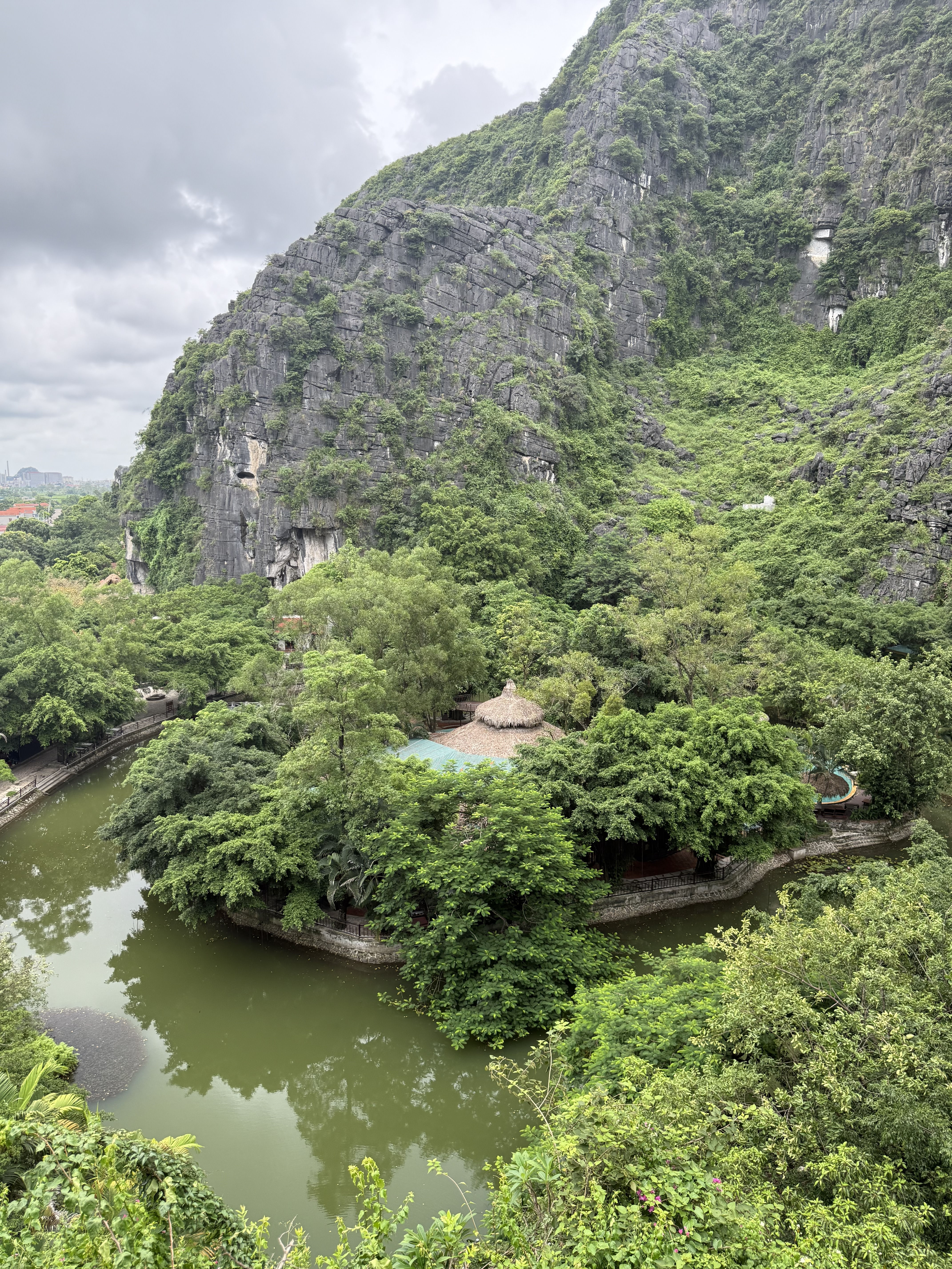 Aerial view of a riverside pavilion amid limestone karsts, Ninh Binh Vietnam