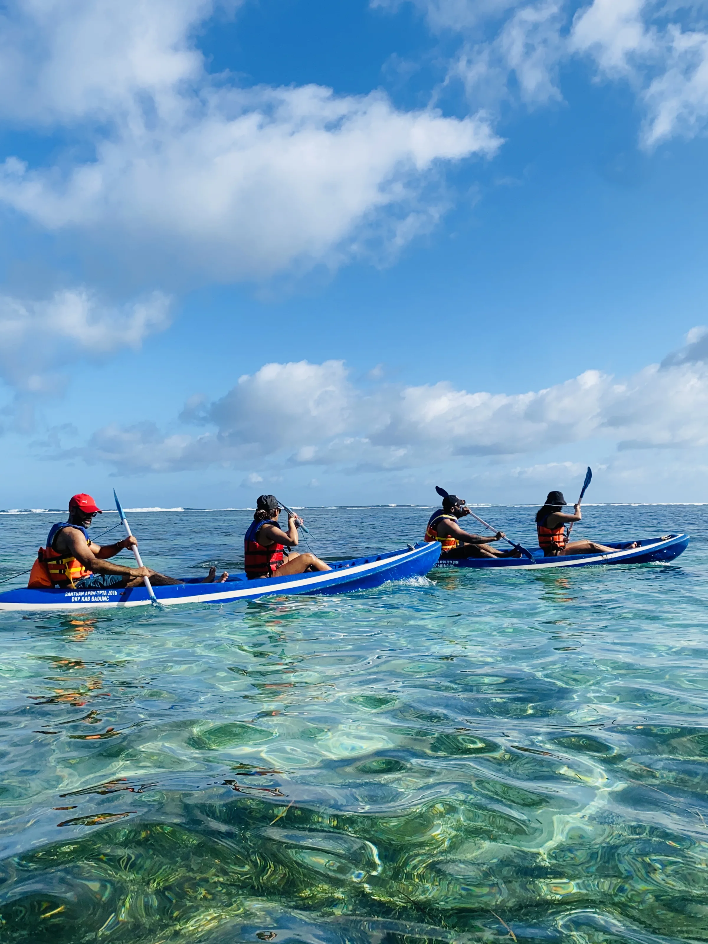 Sea kayaks over clear reef water in Bali