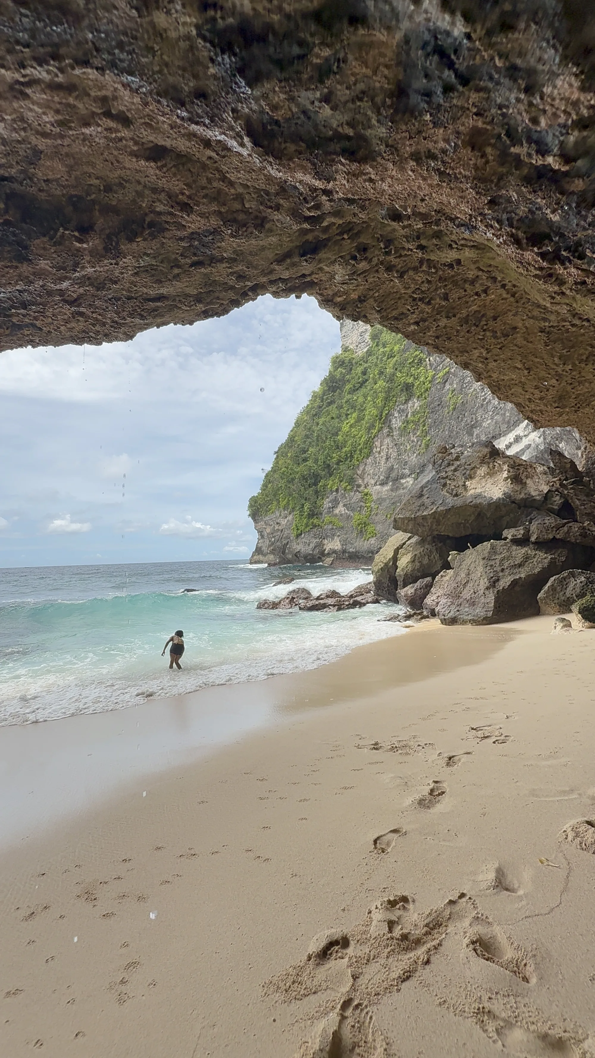 A Bali beach framed by a rock arch