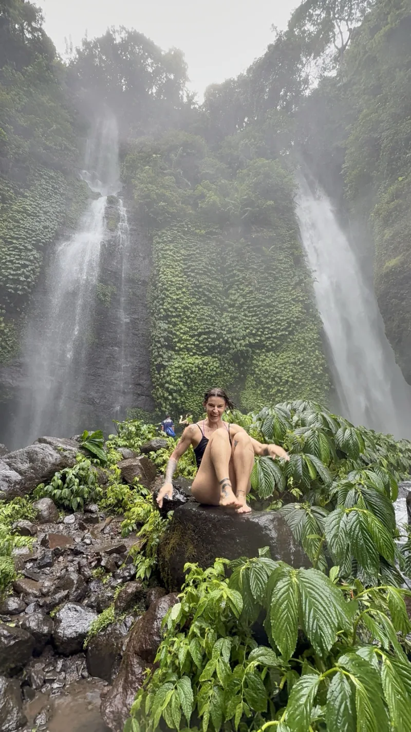 Twin waterfalls in lush green Bali jungle during the green season