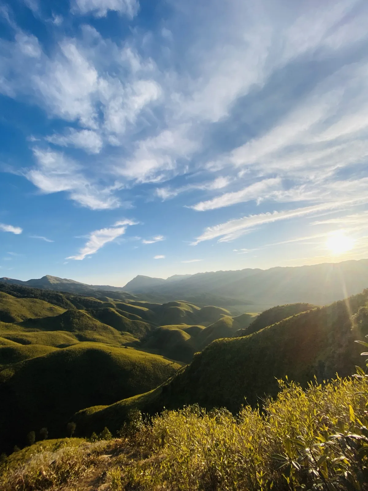 Golden sunrise over the rolling hills of Dzukou Valley, Nagaland