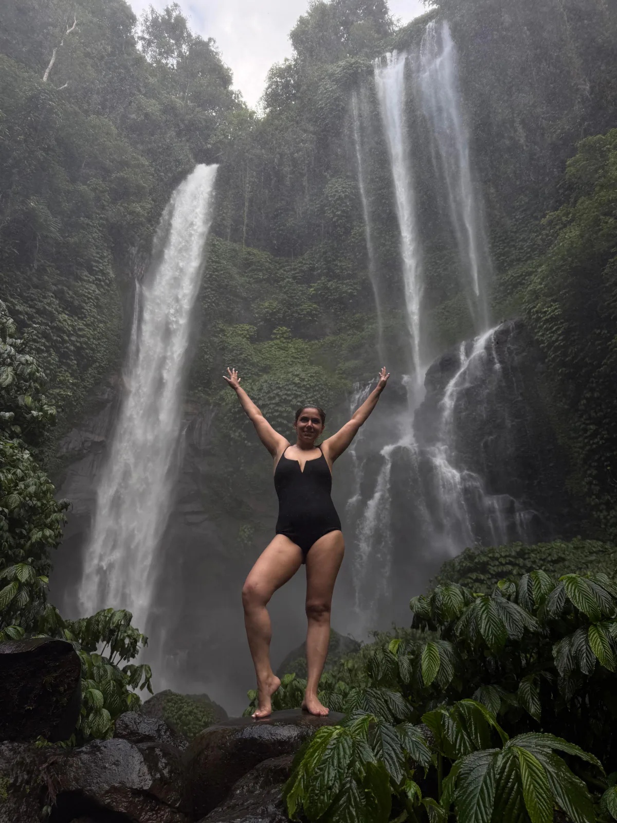 Standing beneath twin jungle waterfalls in Bali